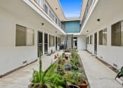 Thumbnail 2 of 3 - a courtyard with potted plants and a staircase