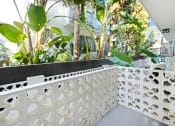 Thumbnail 15 of 34 - a balcony with a white fence and plants