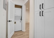 Thumbnail 16 of 34 - a laundry room with white cabinets and a washer and dryer