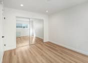 Thumbnail 19 of 34 - a living room with white walls and a sliding glass door