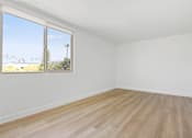 Thumbnail 26 of 56 - Empty room with a window overlooking a tree.