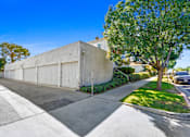 Thumbnail 4 of 4 - A concrete building with a tree in front of it.