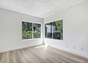 Thumbnail 18 of 24 - A room with a window and a wooden floor.