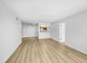 Thumbnail 3 of 24 - A room with wooden flooring and white walls.