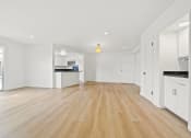 Thumbnail 3 of 11 - the living room and kitchen of a new home with white walls and wood flooring