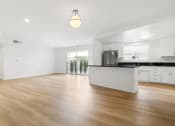 Thumbnail 2 of 11 - the living room and kitchen in a new home with white walls and wood flooring