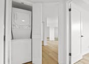 Thumbnail 4 of 11 - a white washer and dryer in a white room with a white door