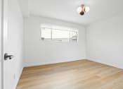 Thumbnail 5 of 11 - an empty room with wood floors and a window