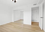 Thumbnail 6 of 11 - an empty living room with white walls and wood floors