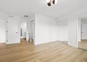 Thumbnail 9 of 11 - an empty living room with white walls and wood floors