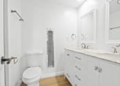 Thumbnail 10 of 11 - a white bathroom with a toilet and a sink