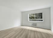 Thumbnail 5 of 10 - A room with a window and a wall-mounted air conditioner.
