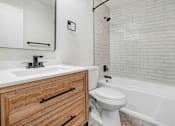 Thumbnail 7 of 17 - a bathroom with a sink toilet and a bath tub