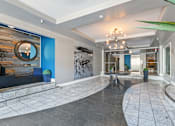 Thumbnail 4 of 5 - A large, open living space with a stone floor and a chandelier hanging from the ceiling.