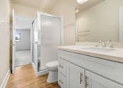 Thumbnail 7 of 13 - A bathroom with a white toilet and a white sink.