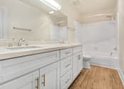 Thumbnail 9 of 13 - A white bathroom with a toilet in the corner.