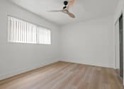 Thumbnail 5 of 9 - A room with a ceiling fan and a window with blinds.