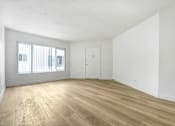 Thumbnail 17 of 28 - A room with wooden flooring and a white door.