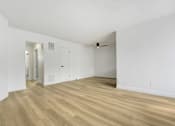Thumbnail 18 of 28 - A room with wooden floors and white walls.