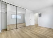 Thumbnail 23 of 28 - A room with a sliding door and a wooden floor.
