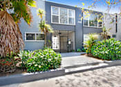 Thumbnail 27 of 28 - A modern house with a grey exterior and a black gate.
