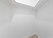 Thumbnail 12 of 28 - A white room with a skylight.