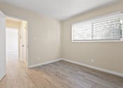 Thumbnail 13 of 28 - A room with a white door and a window with blinds.