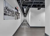 Thumbnail 38 of 39 - A long hallway with a black and white picture on the wall.