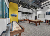 Thumbnail 5 of 39 - A room with a pool table and a yellow wall.