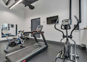 Thumbnail 36 of 39 - A gym with treadmills and exercise bikes.