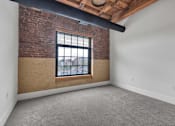 Thumbnail 14 of 39 - A room with a brick wall and a window.