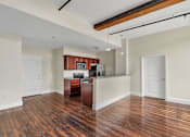 Thumbnail 9 of 39 - A kitchen with wood floors and white walls.