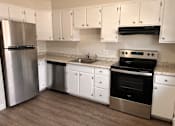 Thumbnail 25 of 25 - a kitchen with stainless steel appliances and white cabinets