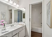 Thumbnail 5 of 19 - A bathroom with a white sink and a white tub.
