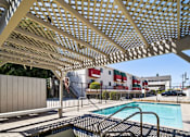 Thumbnail 8 of 17 - A pool under a lattice structure.
