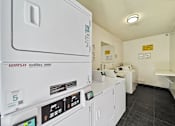 Thumbnail 4 of 7 - A laundry room with a washing machine and a dryer.