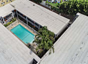 Thumbnail 16 of 21 - A rooftop with a pool and a fence.