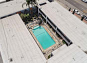 Thumbnail 7 of 21 - A small pool is surrounded by a concrete patio.