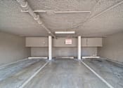 Thumbnail 10 of 21 - A spacious, unfinished room with concrete floors and walls, and exposed pipes on the ceiling.