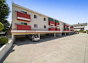 Thumbnail 4 of 17 - A large white building with red and green accents.