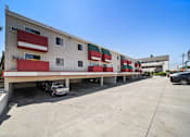 Thumbnail 9 of 17 - A large building with a red and white striped awning.