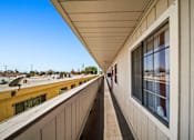 Thumbnail 15 of 17 - A long, narrow building with a balcony overlooking a cityscape.