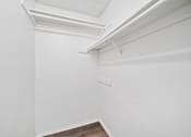 Thumbnail 23 of 25 - A white wall with a brown floor and a white ceiling.