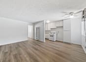 Thumbnail 16 of 25 - A room with a wood floor and white walls.