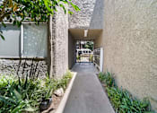 Thumbnail 8 of 25 - A pathway leads to a gate in a courtyard.