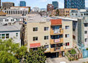 Thumbnail 2 of 6 - A view of a city with buildings of different heights and colors.