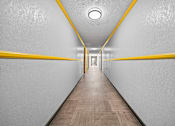 Thumbnail 18 of 19 - A long hallway with yellow lines on the walls.