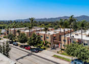 Thumbnail 1 of 7 - A street view of a residential area with cars parked on the side of the road.