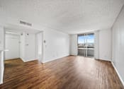 Thumbnail 12 of 27 - A room with wooden floors and white walls.