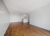 Thumbnail 20 of 27 - A room with wooden floors and white walls.